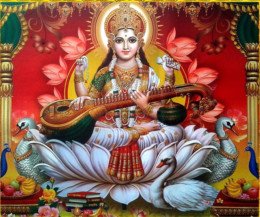 mata saraswati sits on lotus wallpaper